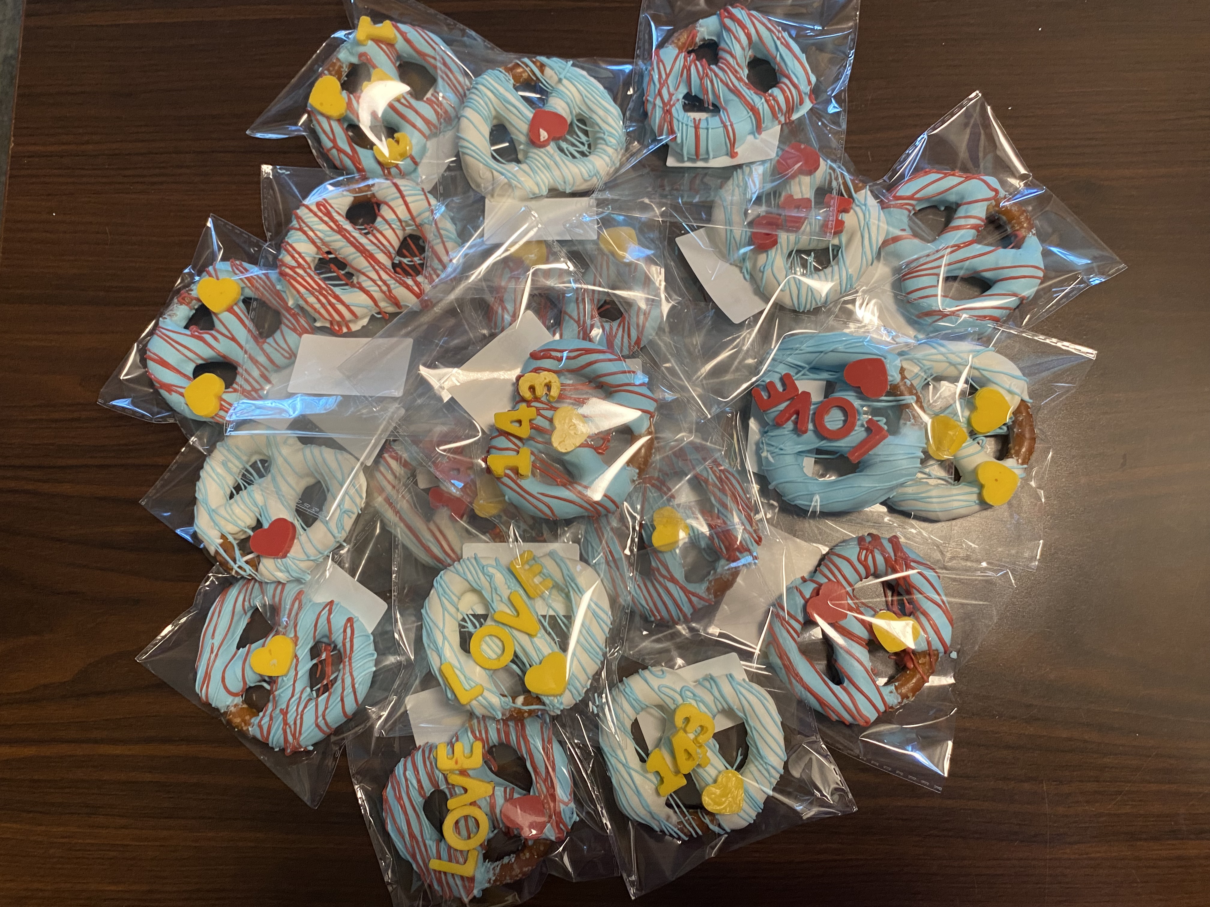 Individually wrapped chocolate-dipped pretzels with colorful decorations