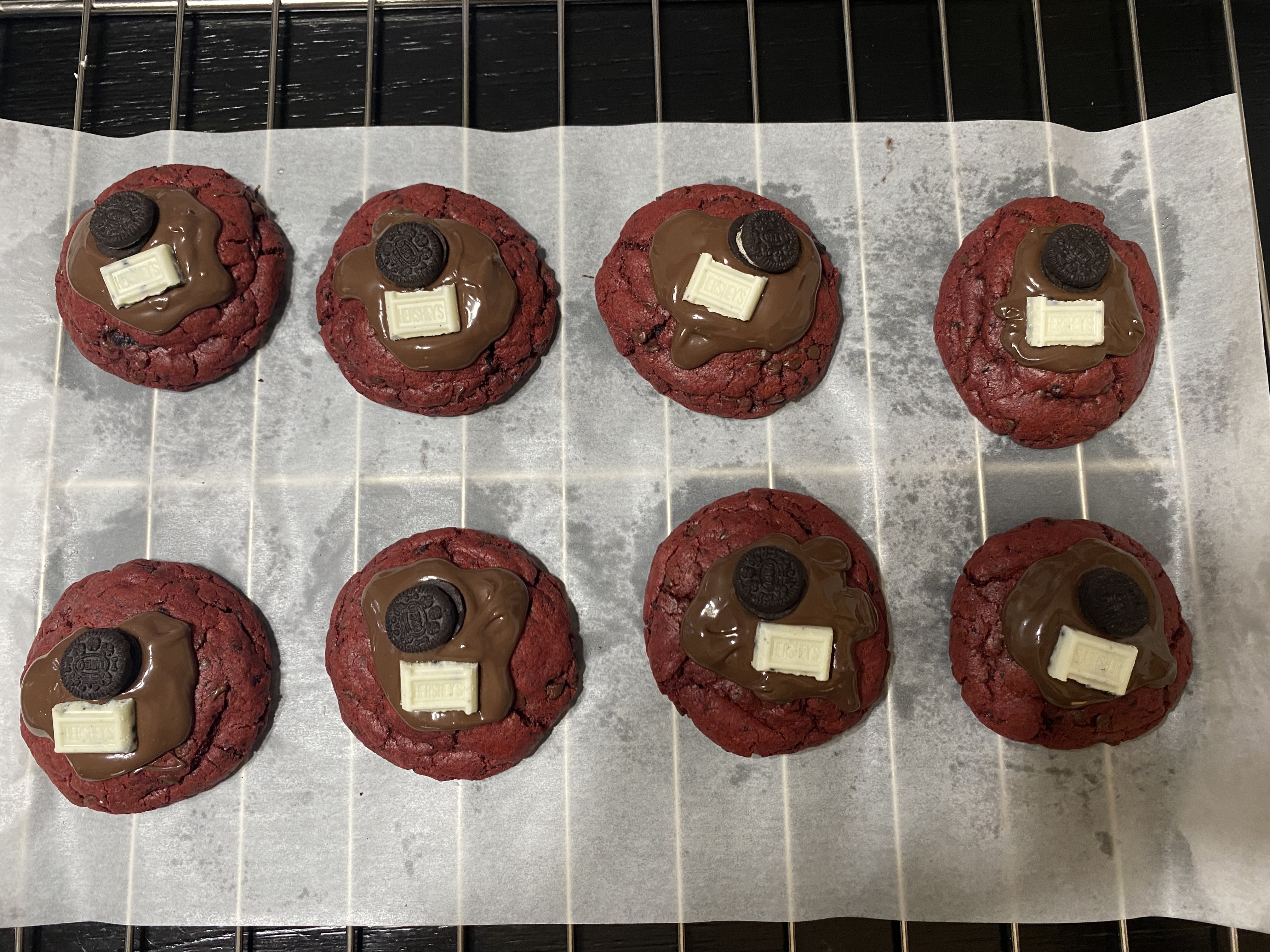 Red velvet cookies topped with chocolate, sandwich cookies, and white chocolate
